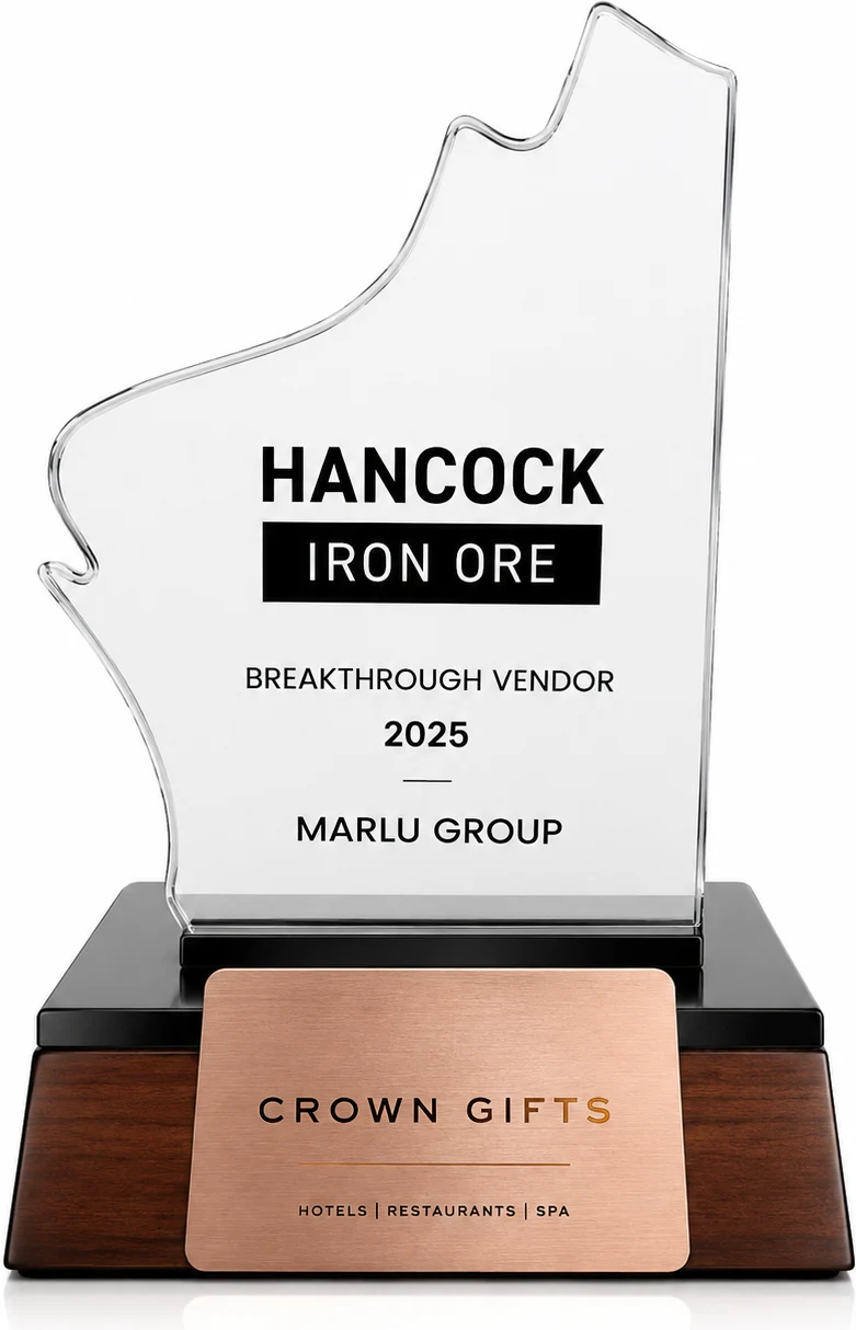 Hancock Iron Ore Breakthrough Vendor 2025 trophy, engraved Marlu Group. A clear angular glass plaque on a black and timber base.