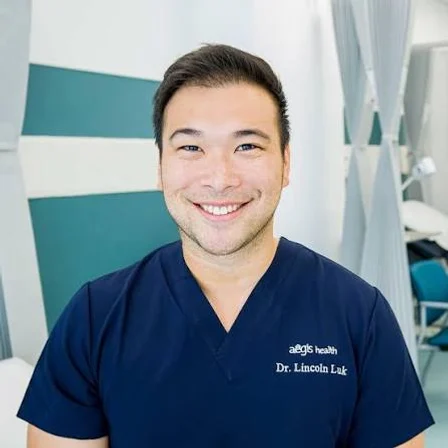 Dr Lincoln Luk, photographed in clinical scrubs.